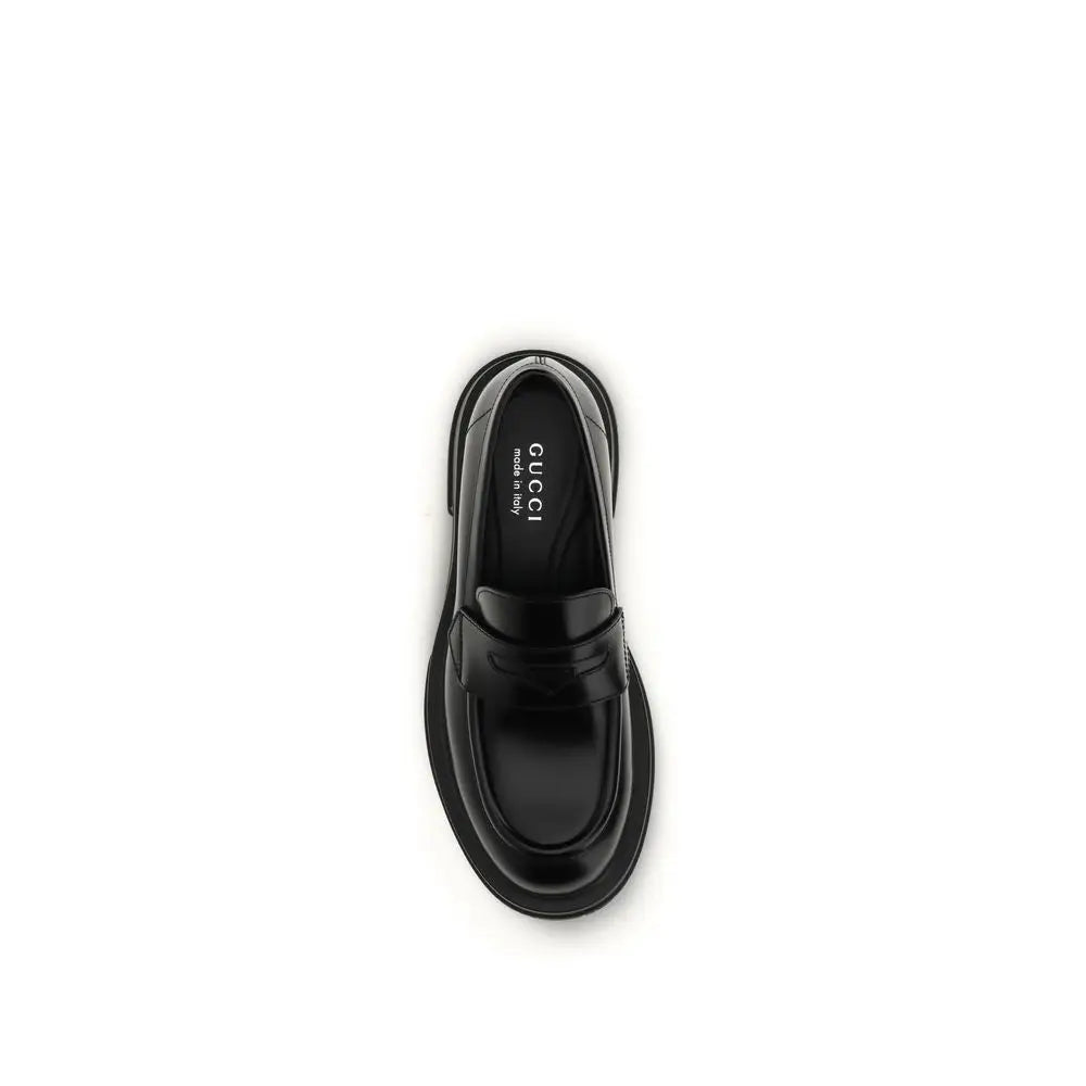 Gucci black calf leather Bos Taurus slip-on loafers with glossy finish and chunky sole